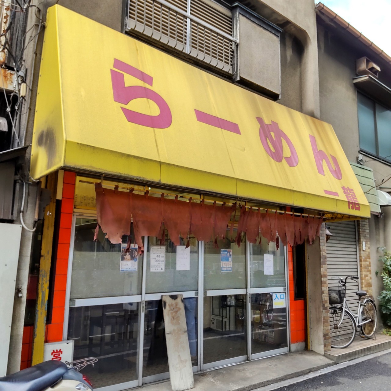 らーめん一龍の外観。黄色いテントに「らーめん」の文字